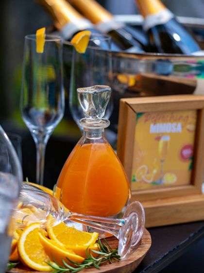 A DIY Mimosa bar is a fun and interactive part of our Summer Cooler Brunch. Guests can mix their own sparkling cocktails with fresh orange juice and garnishes.