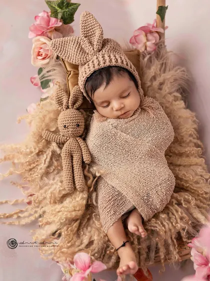 A close up on this sweet little bunny. The knit hat with floppy ears and the matching toy add so much character and charm to the portrait.
