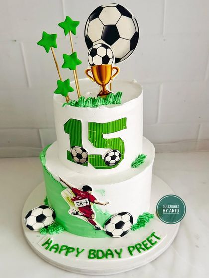 A full view of the action-packed two-tier football cake, perfect for a young sports enthusiast.
