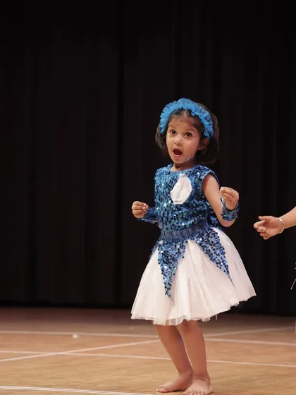 This young dancer is completely in the zone, singing along as she performs. It shows how comfortable and expressive our students become on stage.