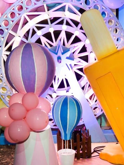 A giant popsicle prop and decorative hot air balloons contribute to the larger-than-life Candyland theme.