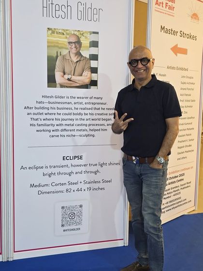 Standing next to my artist bio and the description for my sculpture "Eclipse" at the India Art Festival.