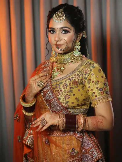 This bride is wearing a unique mustard and maroon lehenga. I used warm tones in her makeup to complement the earthy colors of her outfit.