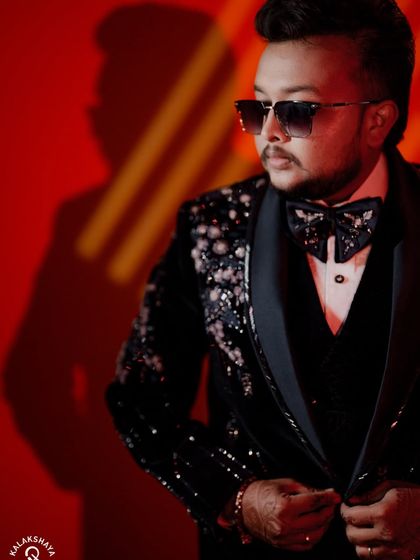 A dramatic portrait of the groom in his reception tuxedo, using creative lighting and shadows.
