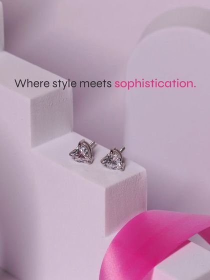 Where style meets sophistication. Our heart-shaped solitaire studs, displayed here, are a testament to timeless, elegant design.