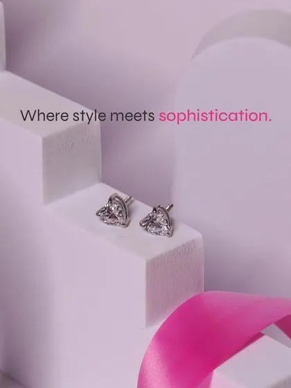 Where style meets sophistication. Our heart-shaped solitaire studs, showcased on a modern display, are a testament to timeless design.