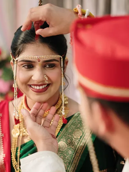 A beautiful close-up of the sindoor ceremony. The bride's joyful, trusting smile as she looks at her partner makes this a powerful and emotional photograph.