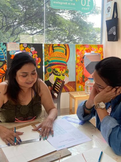 An instructor and student review a drawing together. One-on-one interaction is a key part of our teaching philosophy.