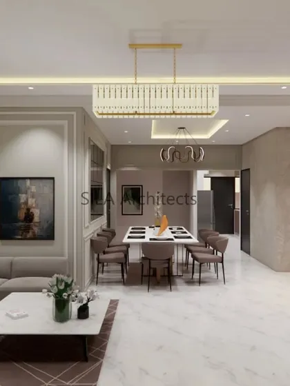 The dining and living area of our European-themed design. This view highlights the classic wall molding, modern chandeliers, and an open layout that is perfect for both family life and entertaining guests.