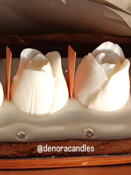A close-up of the white tulip boat candle, accented with small pearls.