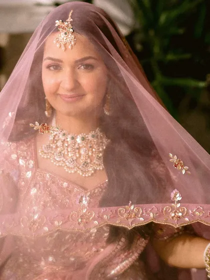 A stunning close-up of the bride looking through her sheer pink veil, her happy tears shimmering in her eyes.