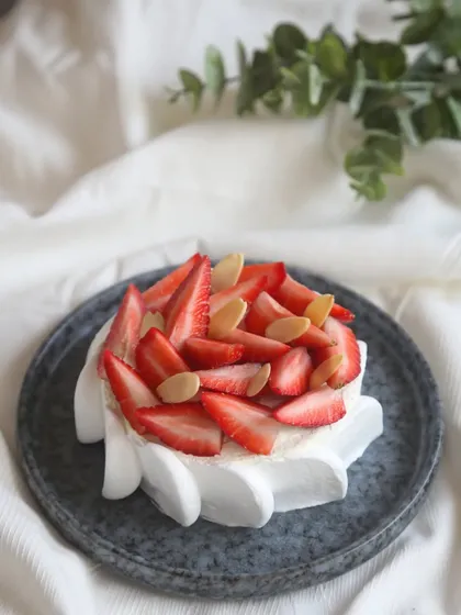 Our eggless Strawberry Feta Cheesecake is a unique delight, topped with fresh strawberries and almond slivers.