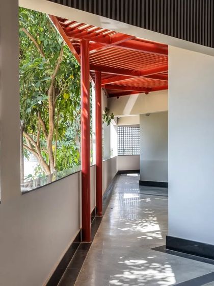 The covered walkways at L'Atelier are designed to be extensions of the learning environment, blurring the lines between indoors and outdoors.