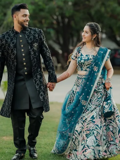 Your wedding story includes moments of fun and celebration. This shot from a Sangeet ceremony captures the couple walking hand-in-hand, sharing a laugh. It shows the blend of candid photography and stylish portraits I provide for all your events.