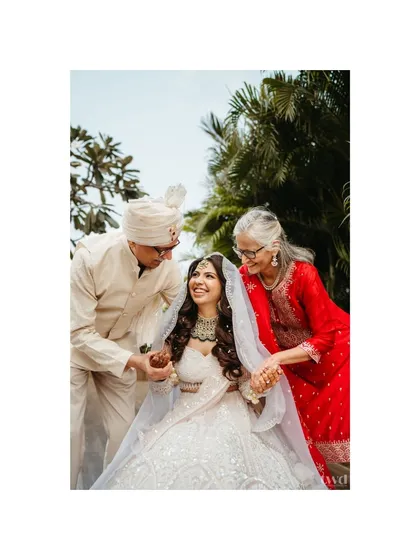 A priceless moment between the bride and her parents. Their joyful expressions and loving embrace make this one of the most heartwarming photos of the day.
