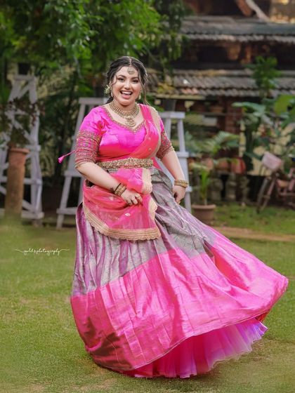 The twirl of the lehenga skirt creates a beautiful sense of movement and celebration. This is a classic shot for any bride.