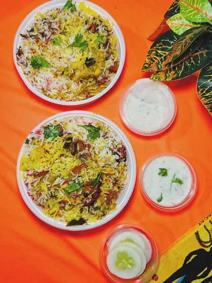 A typical meal for two from my kitchen. Each plate of biryani is served with fresh raita and a simple salad to complete the experience.