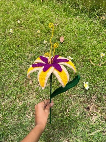 Our 'Tangled' flower enjoying some time outside. The natural light really makes the yellow and purple yarn colors pop.
