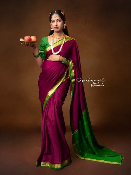 A full-length portrait showcasing the elegant drape of the saree and the classic pose that defines this artistic style.