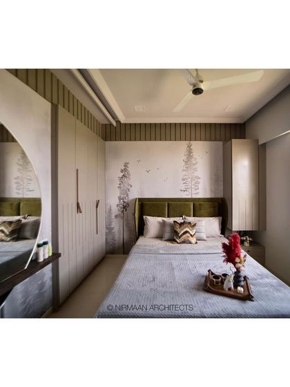 This master bedroom combines a custom wardrobe with an integrated dressing table featuring a large, curved mirror. The design is seamless, functional, and effortlessly chic.