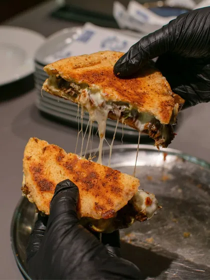 The perfect cheese pull from a smashed Poee sandwich at our pop-up with Chef Rhea Aaron. It's this kind of comforting, messy, and utterly delicious food that makes our more casual 'Shop' events so special.