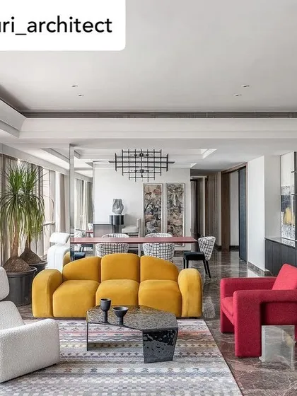 A panoramic view of a sea-facing Mumbai residence where our furniture creates a dialogue between art and design. This living space features our vibrant yellow sofa, a sculptural red armchair, and a free-flowing white lounge chair, all set against the backdrop of the city skyline.