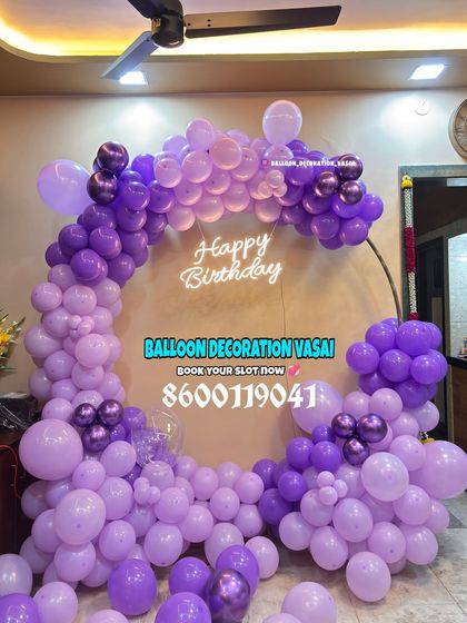A full ring of purple balloons with a neon sign. This is a great option for a stylish yet simple birthday backdrop.