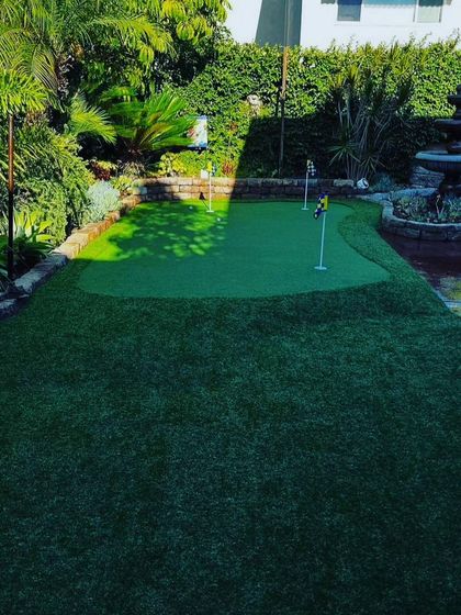 Another view of the garden green, showing how it works with the existing fountain and stone patio. The shape is completely custom to the client's space.