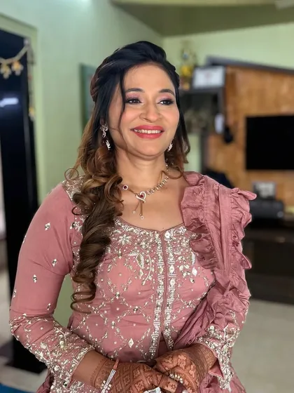 An elegant look for a mature client in a dusty rose outfit. The makeup is soft and glowing, with a focus on her eyes.