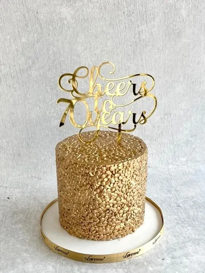 A glamorous all-gold cake to celebrate 70 years. The entire cake is covered in gold sequins for a dazzling, celebratory effect.