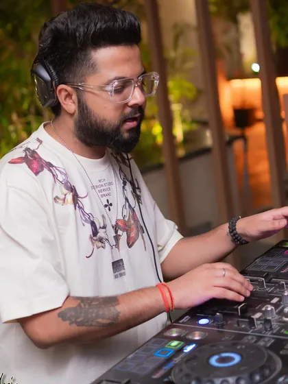 A close-up of me at the console, surrounded by the warm lighting of the venue.