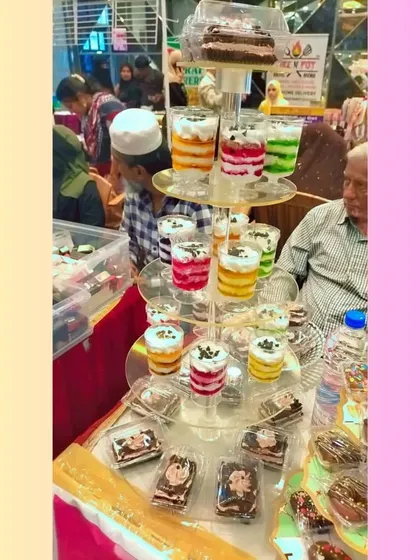 My dessert cups are perfect for events. Here you can see a tower of my layered mousse cups in different flavors like mango, black currant, and red velvet, all 100% eggless.