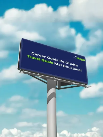 A friendly reminder on a billboard: "Career goals ke chalte travel goals mat bhul jana!" Don't forget to live while you're making a living.