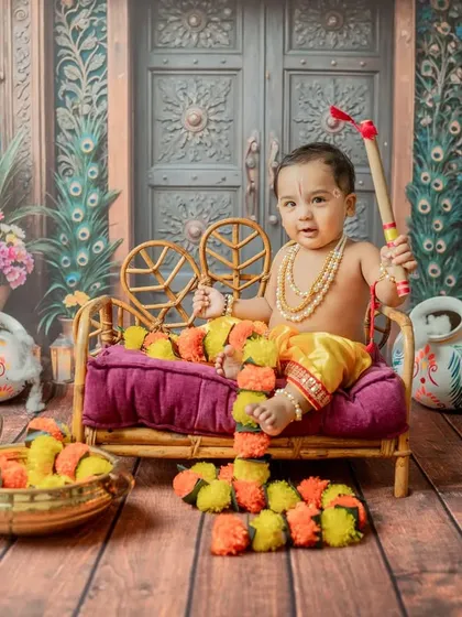 A regal pose on a miniature sofa, holding his 'gada' (mace), showcasing a different aspect of the Krishna story.