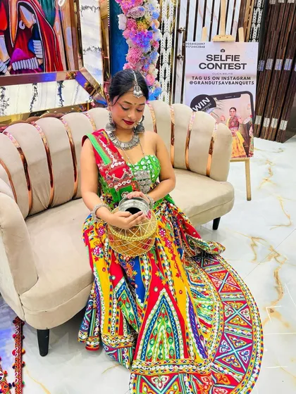 Feeling like royalty in this incredibly detailed and colorful lehenga. The wide, embroidered border and matching potli make this a truly special occasion outfit.