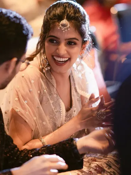 A close-up of the bride's flawless, natural radiance. This look is all about subtle hues and a chic ponytail, perfect for a modern sangeet.