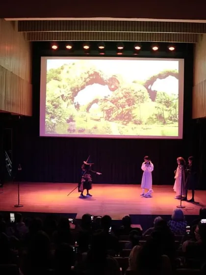 A view from the audience captures the scale and energy of our productions. Our goal is to create a complete theatrical experience where children perform for a live, engaged audience, learning to manage stage presence and audience interaction.