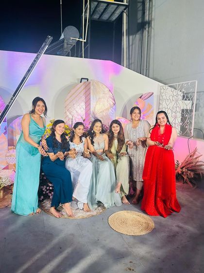A behind-the-scenes group shot of the bride and her friends at the mehndi party.