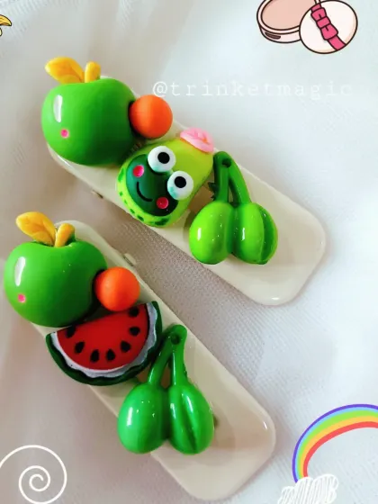These fruity-themed hair clips are so much fun. They feature a watermelon slice, an apple, cherries, and a cute frog character.