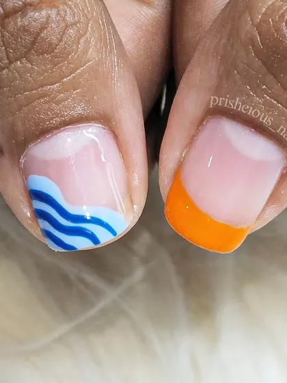 A close-up of the funky art, showing the tiny waves and orange French tip. It's all about having fun with your nails.