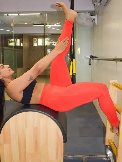 A single leg stretch on the Ladder Barrel. This is an amazing way to open up the hips and lengthen the hamstrings while engaging your core for stability.