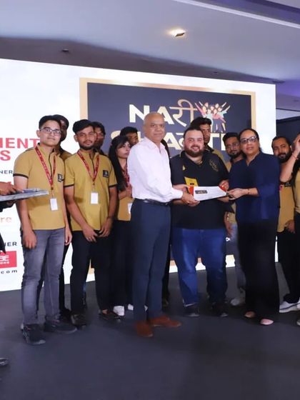 Our team receiving an award on stage at the National Fashion Show Season 3 for their exceptional hairstyling work.