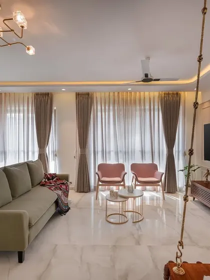 This living room captures our love for soft, pastel hues that create a lively and chic atmosphere. The traditional wooden swing adds a personal touch, blending modern furniture with timeless Indian elements to make the space feel like home.