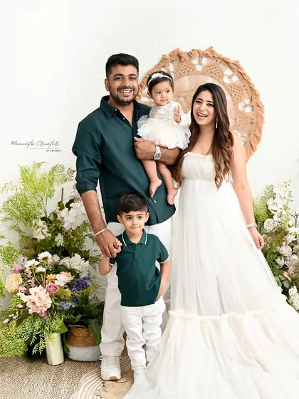 A classic family pose, full of warmth and happiness. The coordinated outfits and natural smiles make this a perfect keepsake for this family of four.