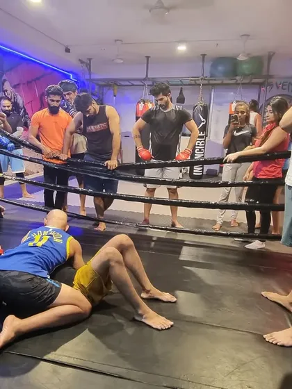 We are starting dedicated Brazilian Jiu-Jitsu classes. Here, our coach demonstrates a ground technique to the class, focusing on leverage and control, which are essential for self-defense and MMA grappling.