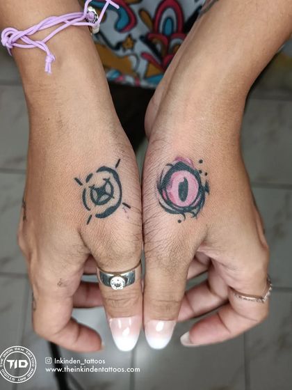 Matching hand tattoos for a Valorant fan, featuring the ability icons for the characters Reyna and Viper. These small, symbolic pieces are a creative way to show your love for the game.