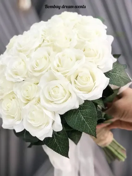 A classic and elegant bridal bouquet made of beautiful white roses, perfect for a white wedding or reception look.