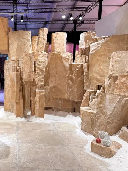 A landscape of salt crystals in our 'Salt' installation. The ground is covered in fine salt, and the space is filled with large, geometric forms that evoke natural salt rock formations.