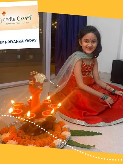 This little girl looks radiant in her custom red Anarkali suit, perfect for a Diwali puja. The outfit features a simple yet elegant design with a contrasting light blue dupatta.