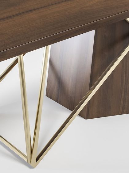 A close-up of the dining table's base, highlighting the seamless joinery between the wooden and metal elements, a testament to our craftsmanship.